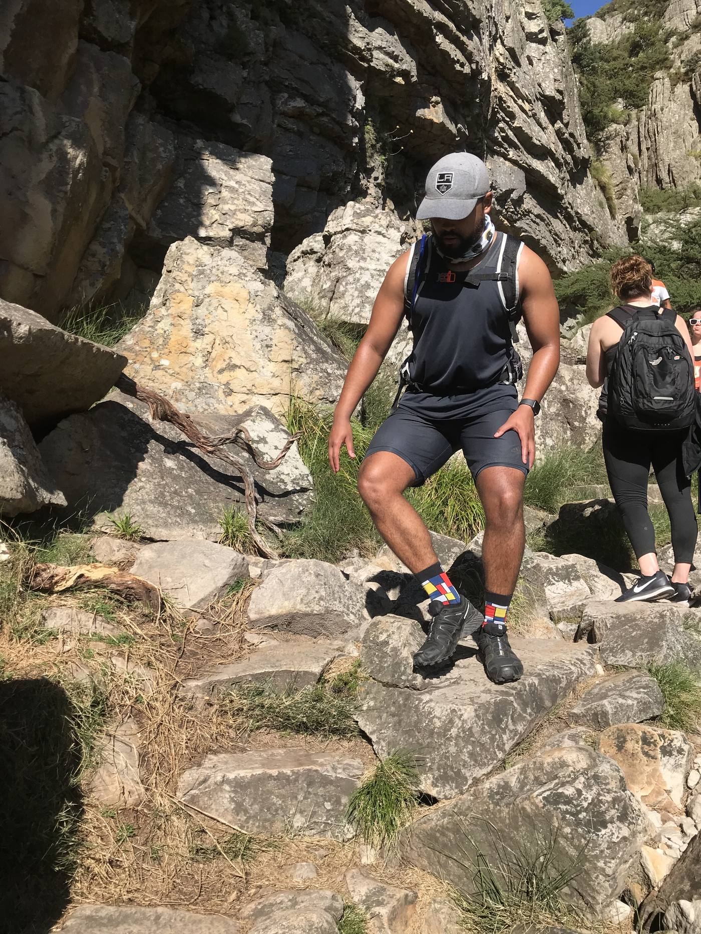 Shaun Cedric Thomas hiking solo on a rocky mountain trail